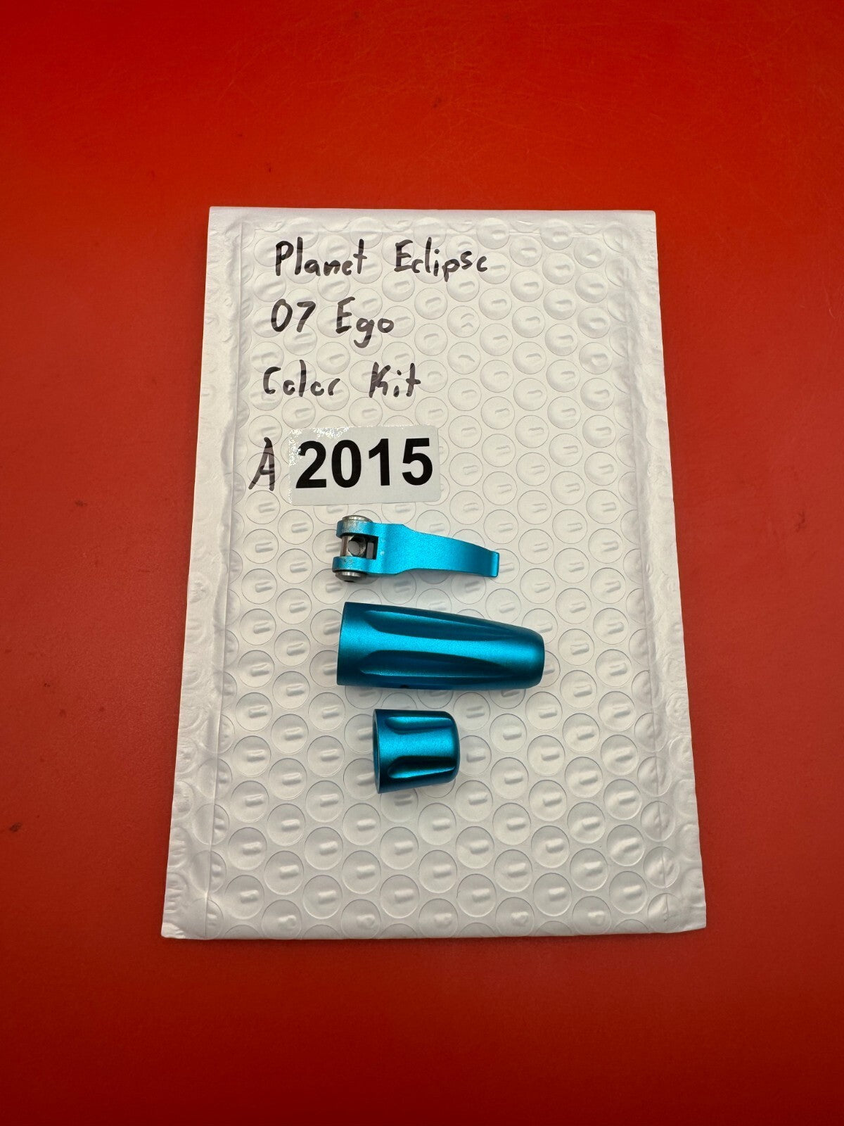 Planet Eclipse 07 Ego Color Kit - used paintball color kit (trigger, lpr cap, asa thumb screw) - teal anno