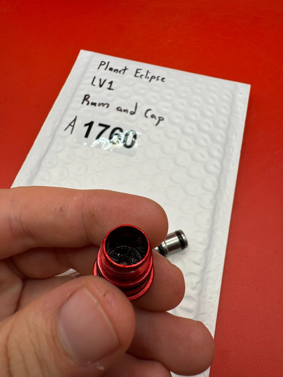 Planet Eclipse LV1 Ram and Cap - used paintball ram and cap assembly - red anno / stainless