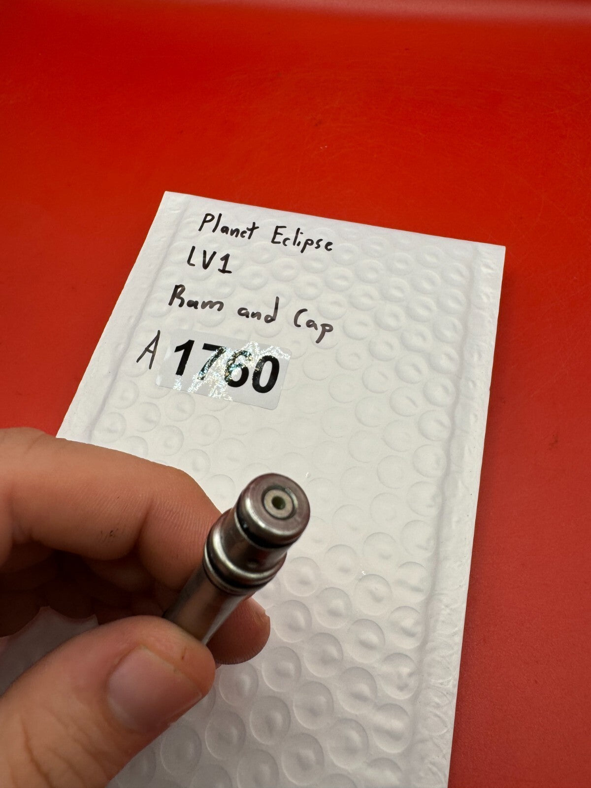 Planet Eclipse LV1 Ram and Cap - used paintball ram and cap assembly - red anno / stainless