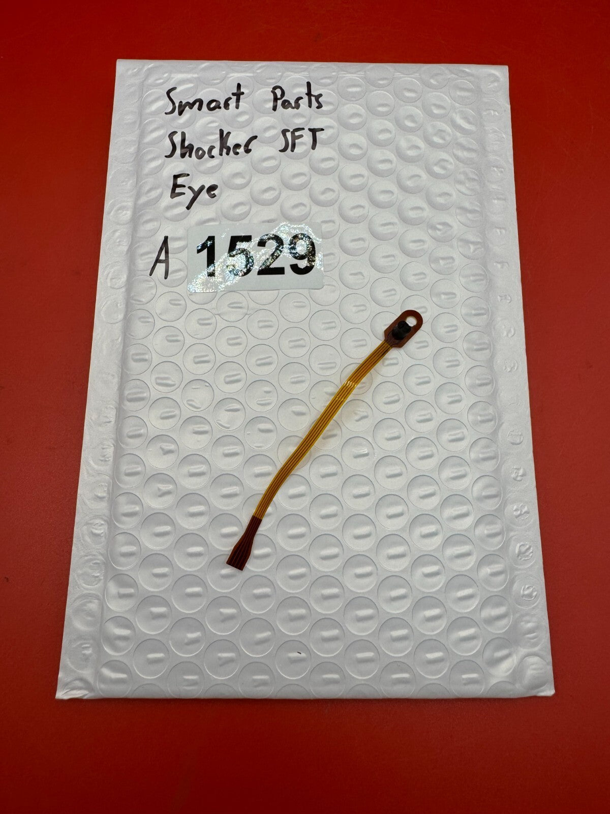 Smart Parts Shocker SFT Eye - used paintball eye (ball detent sensor / anti-chop eye) - amber/brown