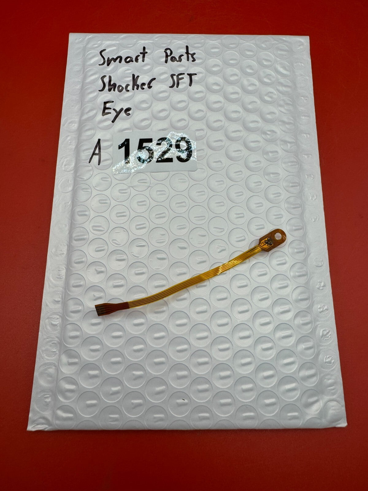 Smart Parts Shocker SFT Eye - used paintball eye (ball detent sensor / anti-chop eye) - amber/brown
