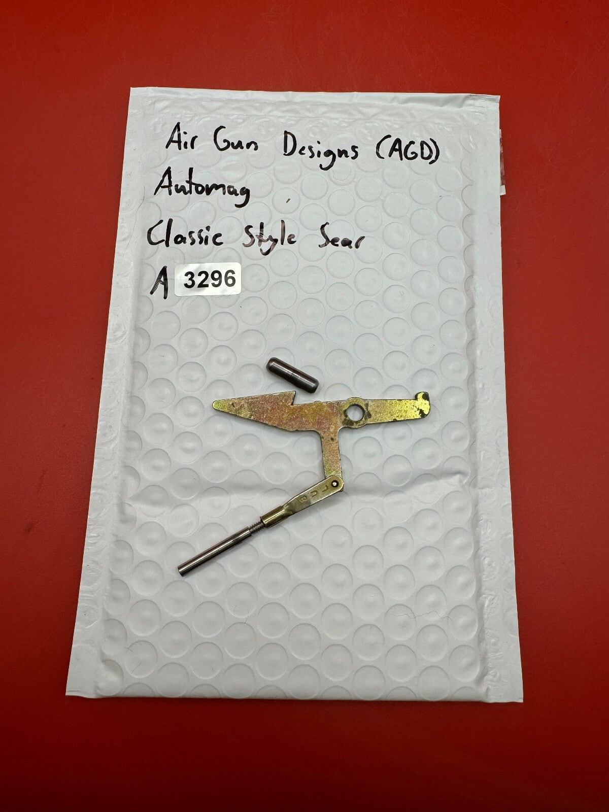 Air Gun Designs (AGD) Automag Classic Style Sear - used paintball sear - gold/silver