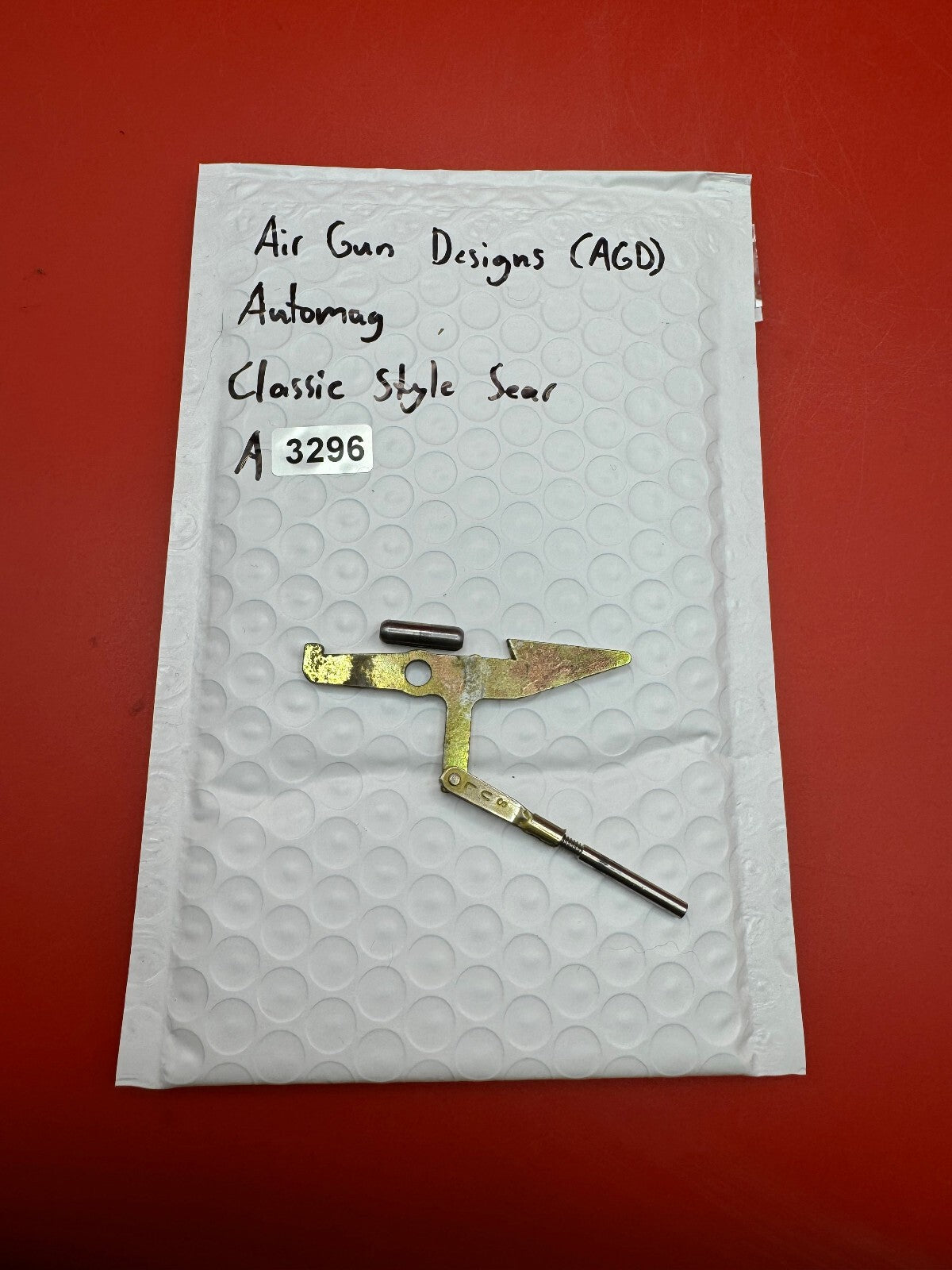 Air Gun Designs (AGD) Automag Classic Style Sear - used paintball sear - gold/silver