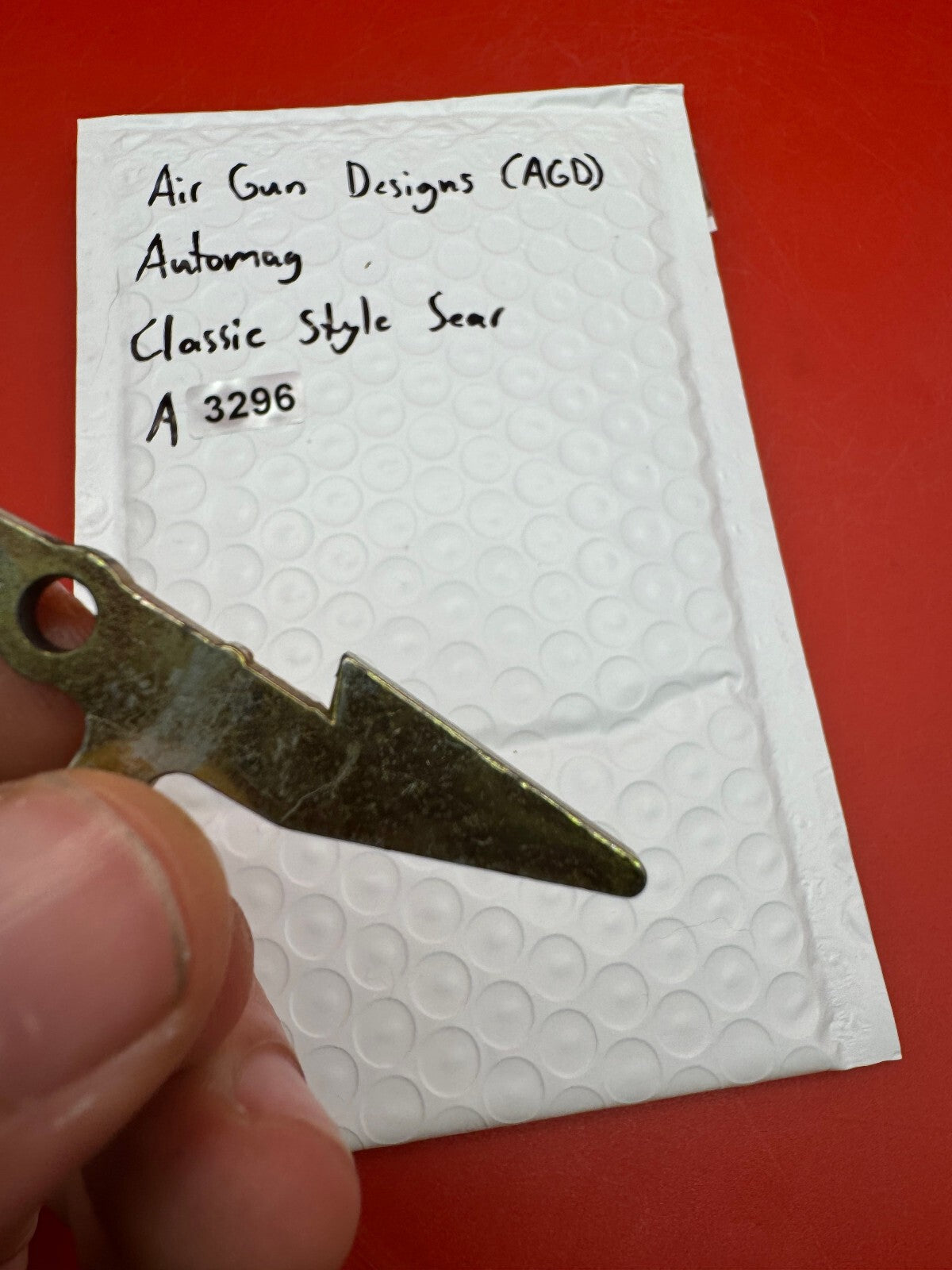 Air Gun Designs (AGD) Automag Classic Style Sear - used paintball sear - gold/silver